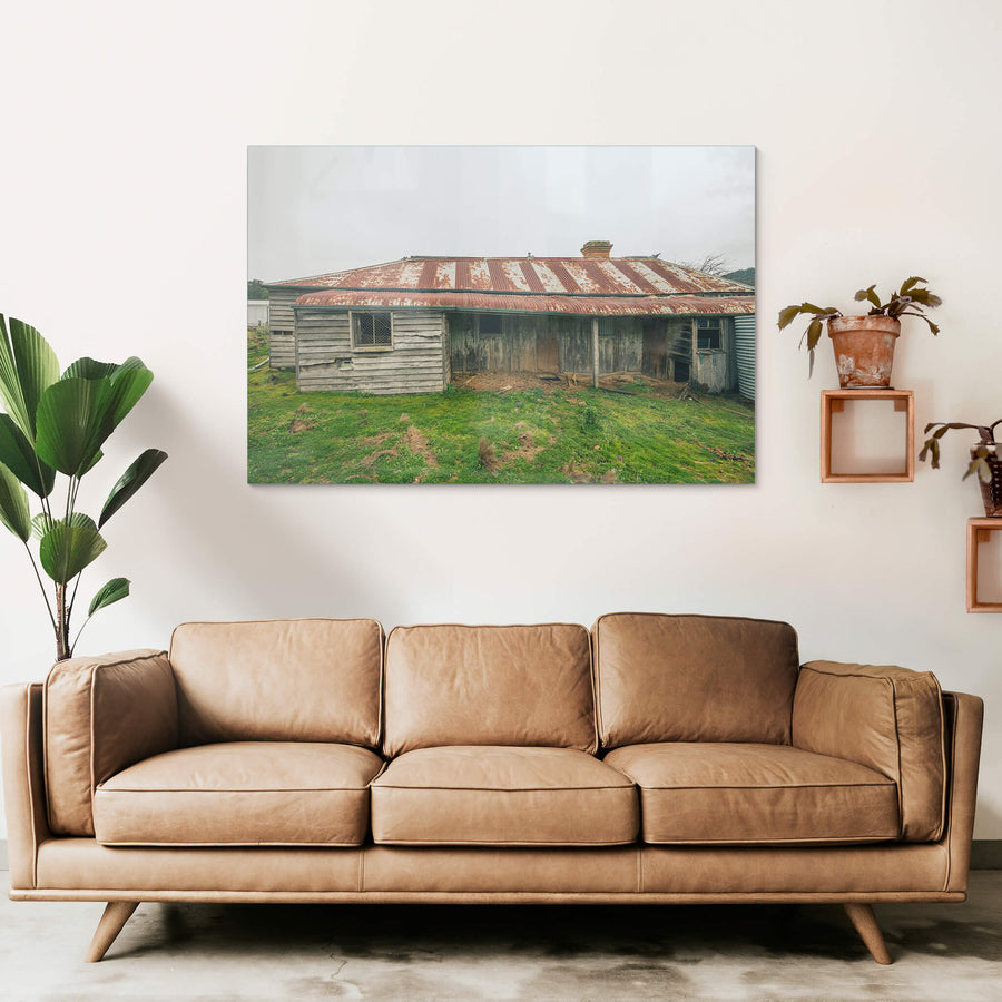 Front Yard at The Post Office, a low-slung timber homestead sits under a corrugated iron roof mottled with rust.