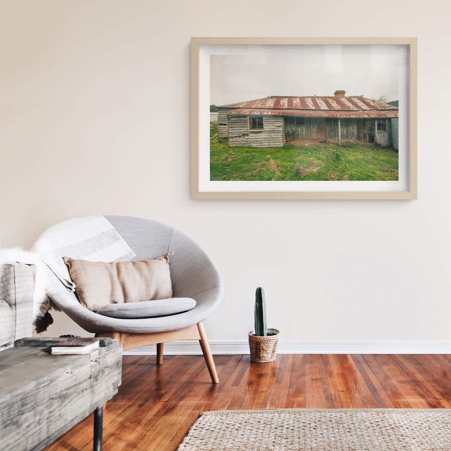 Front Yard at The Post Office, a low-slung timber homestead sits under a corrugated iron roof mottled with rust.