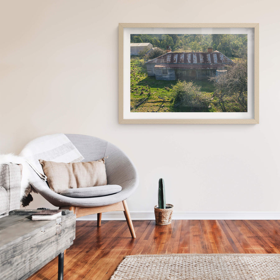 Frontside Elevated at The Post Office, a weatherboard homestead sits low against green pasture, seen from above.