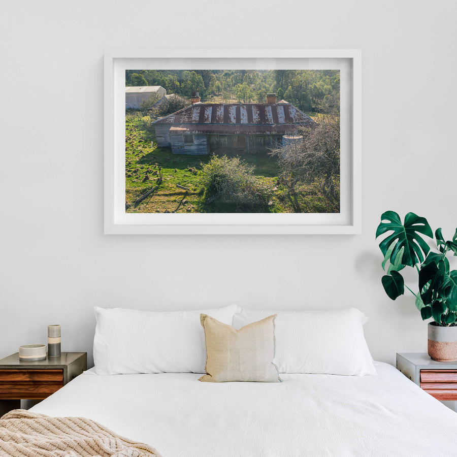 Frontside Elevated at The Post Office, a weatherboard homestead sits low against green pasture, seen from above.