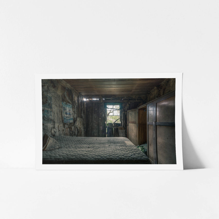 Over the Bed at The Post Office, a bare mattress fills most of the narrow room.