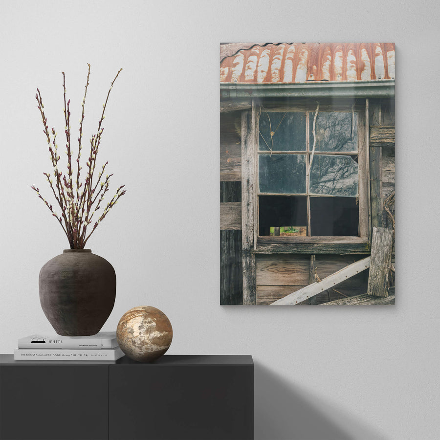 Window Panes at The Post Office, a six-pane timber window set into weatherboard cladding, grey and split with age.
