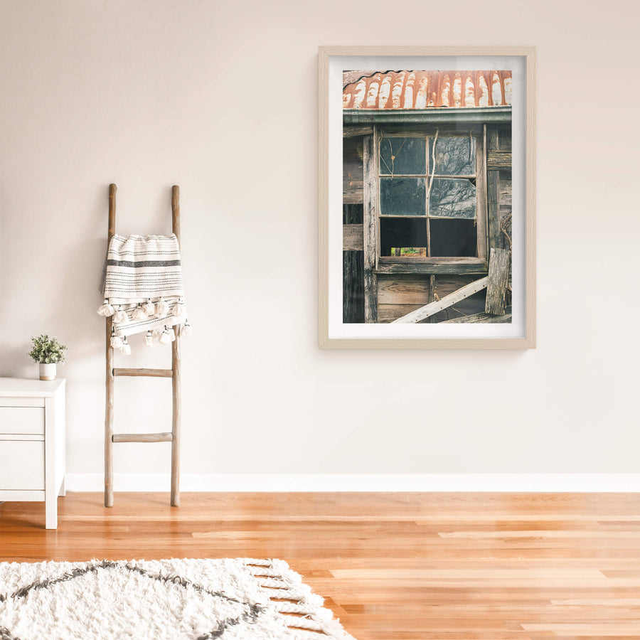 Window Panes at The Post Office, a six-pane timber window set into weatherboard cladding, grey and split with age.