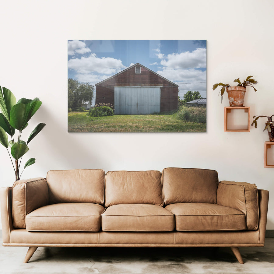 Colac Garden Shed at The Woolshed, a corrugated iron shed sits square to the frame, its walls stained deep rust-red.