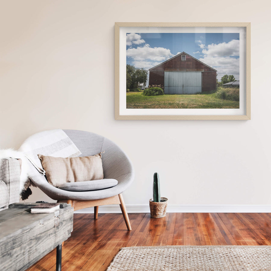 Colac Garden Shed at The Woolshed, a corrugated iron shed sits square to the frame, its walls stained deep rust-red.