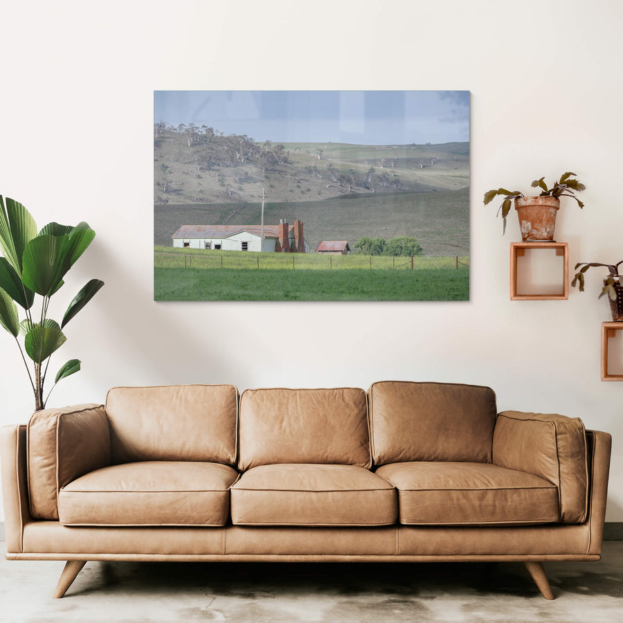 Maffra Shearers Quarters at The Woolshed, a weatherboard shearing quarters sits low in green pasture, its corrugated iron.