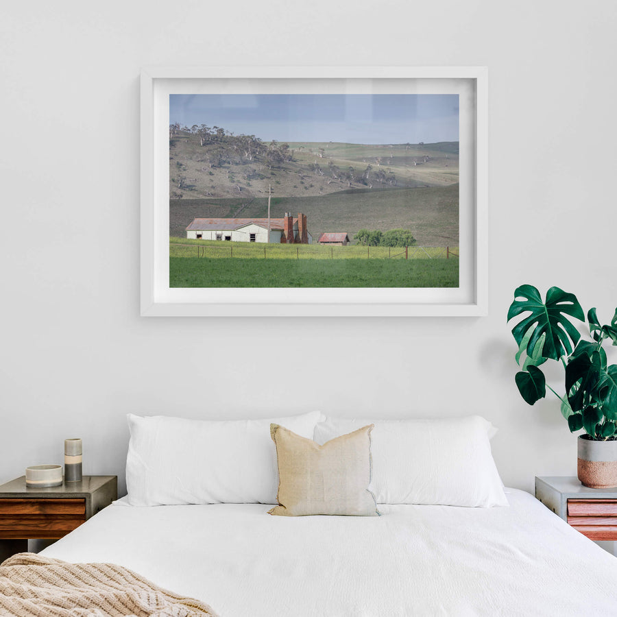 Maffra Shearers Quarters at The Woolshed, a weatherboard shearing quarters sits low in green pasture, its corrugated iron.