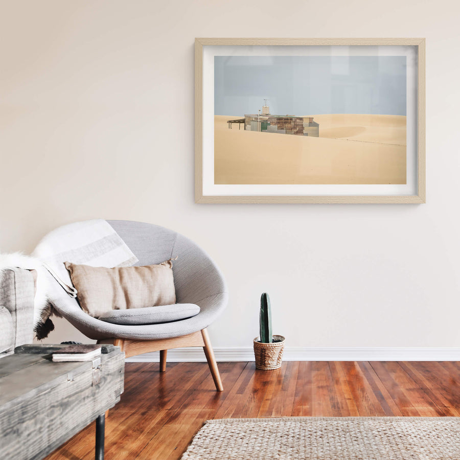 Buried at Tin City, a Tin City shack, recessed in rolling dunes of sand.