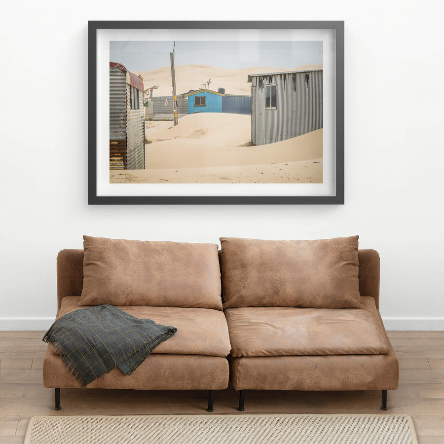 City Centre at Tin City, sand drifts between corrugated iron shacks, banking against walls in smooth curves.