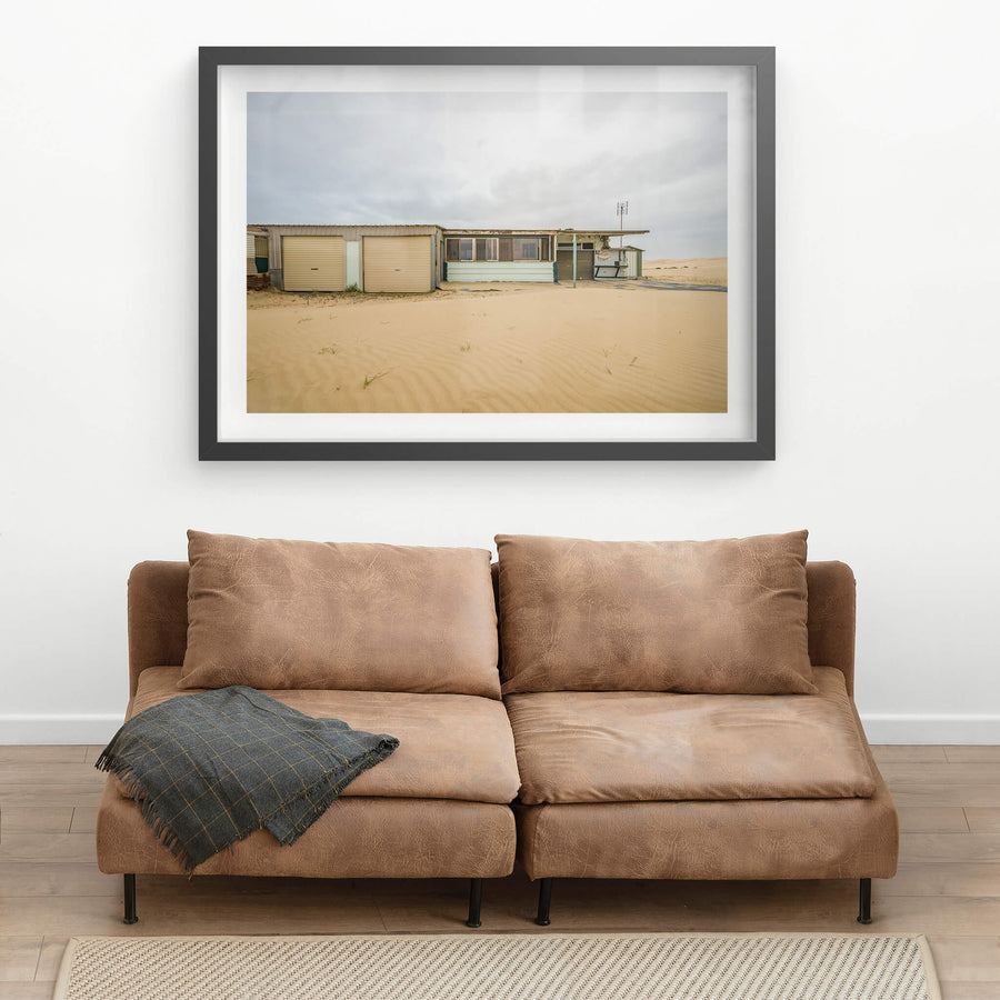 Eight at Tin City, sand drifts in low ripples across what used to be ground level.