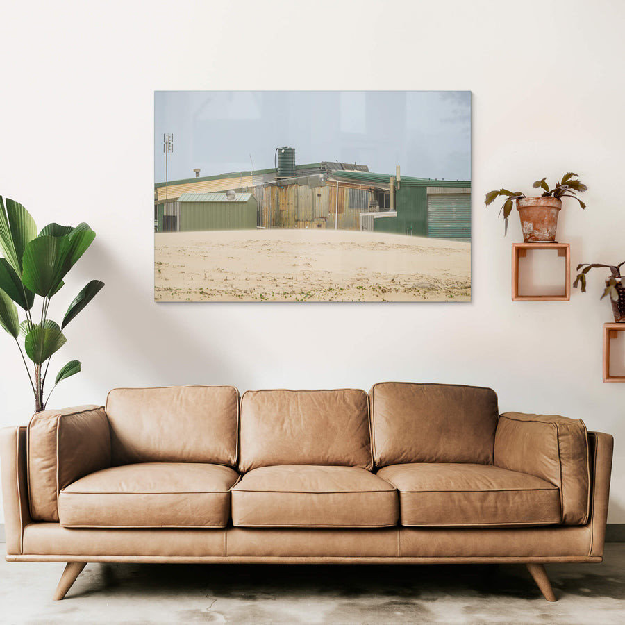 Patchwork at Tin City, green and rust-brown corrugated iron panels sit side by side across a long, low structure.