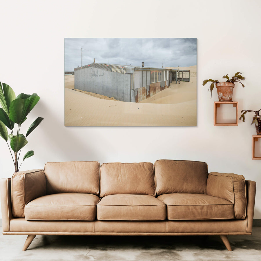 Recess at Tin City, sand banks hard against corrugated iron walls, rising halfway up the structure.