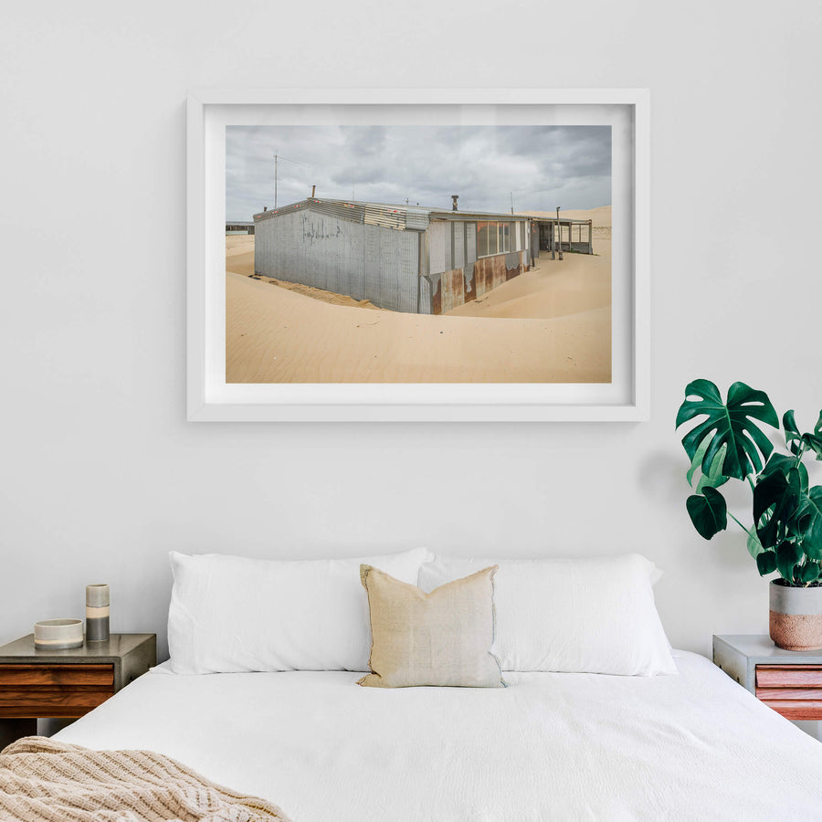 Recess at Tin City, sand banks hard against corrugated iron walls, rising halfway up the structure.