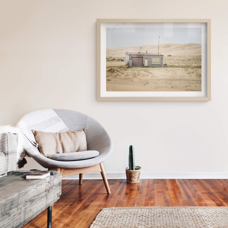 Seven Seven South West at Tin City, shack number seven sits alone against a wall of sand dunes that rises behind it like.
