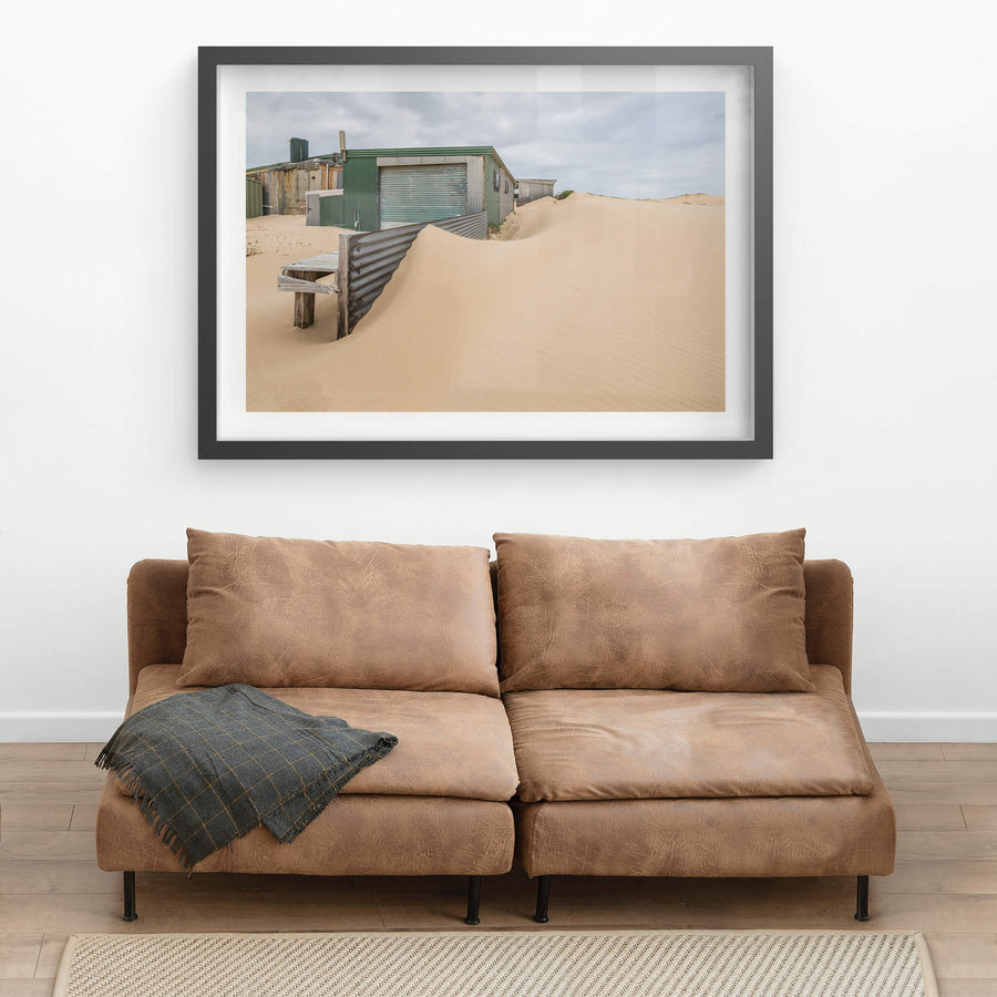 The Outskirts at Tin City, sand dunes press against corrugated iron sheds on the outer edge of Tin City.