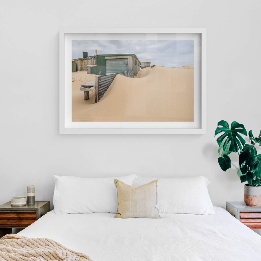 The Outskirts at Tin City, sand dunes press against corrugated iron sheds on the outer edge of Tin City.