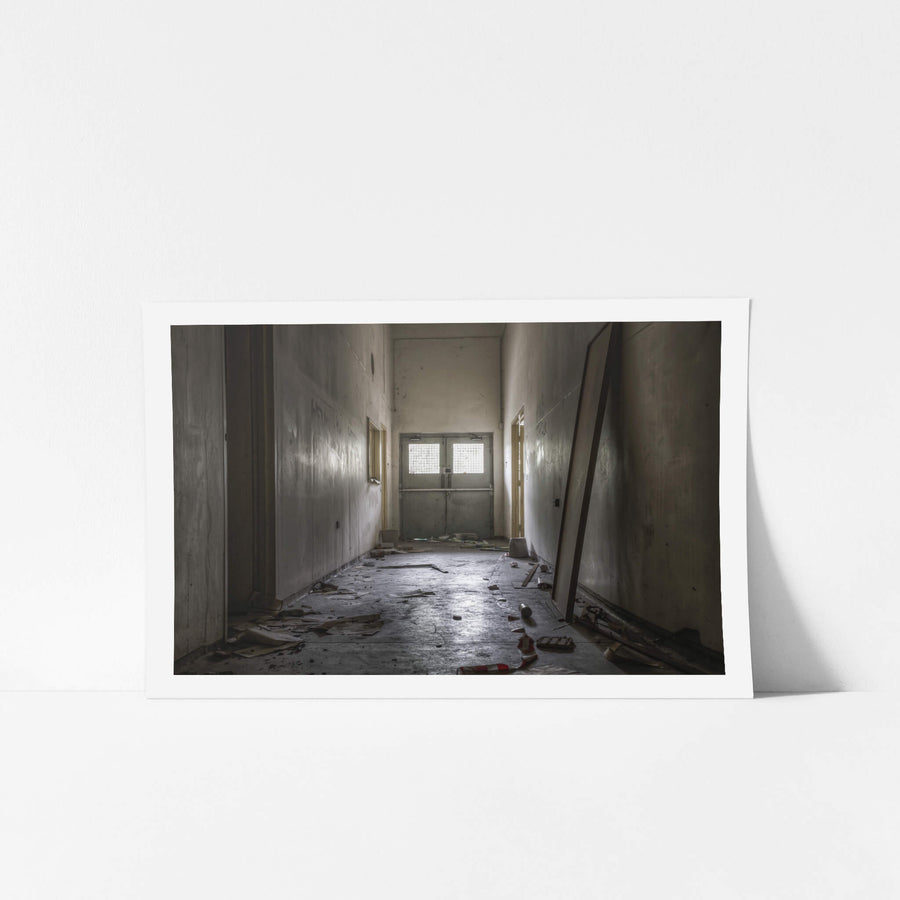 Hallway at Wangi Power Station, a narrow corridor runs toward a pair of steel double doors.