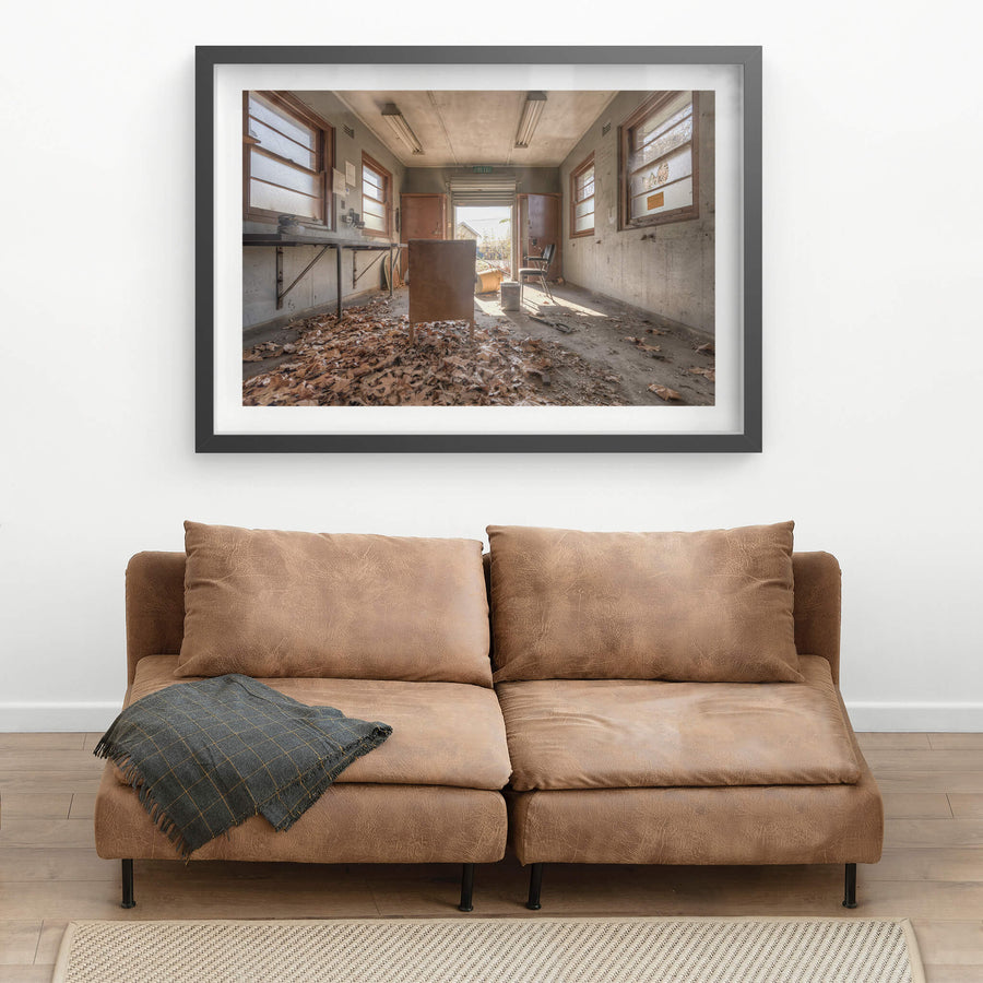 Fallen at Waterfall Sanatorium, dead leaves surrounding a chair in a small utility room.