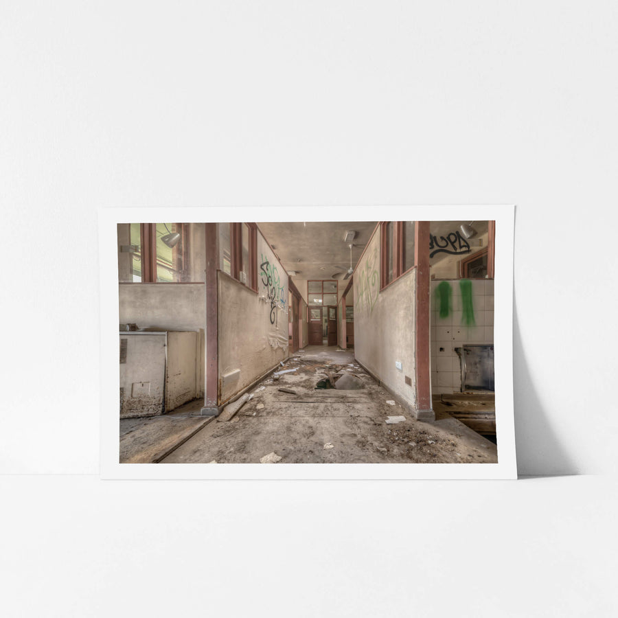 Fallen Through at Waterfall Sanatorium, a corridor runs between partitioned rooms, their maroon-trimmed frames holding.