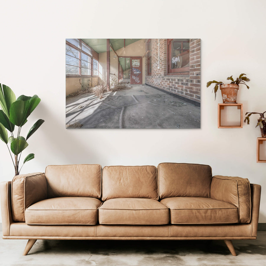 Indoor Plants at Waterfall Sanatorium, a covered walkway runs along the brick facade of a ward building.