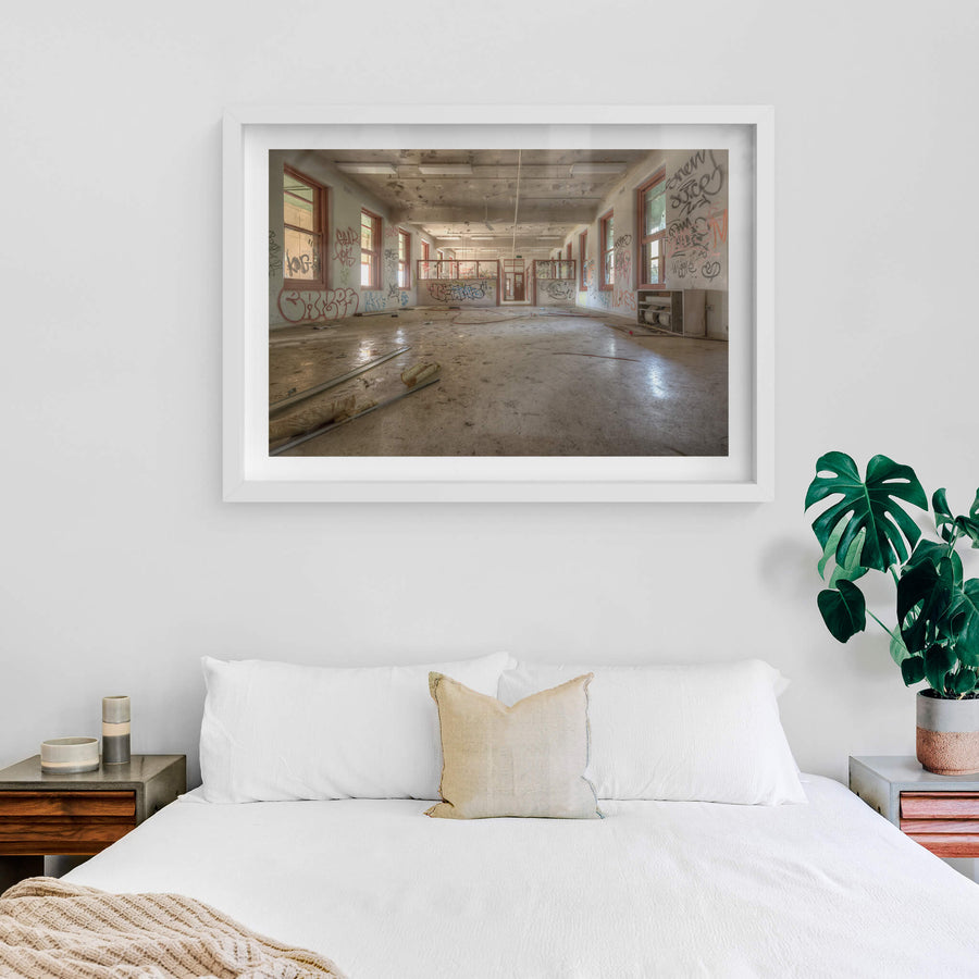 Looking Down The Ward at Waterfall Sanatorium, a long open room stretches back toward a partitioned doorway.