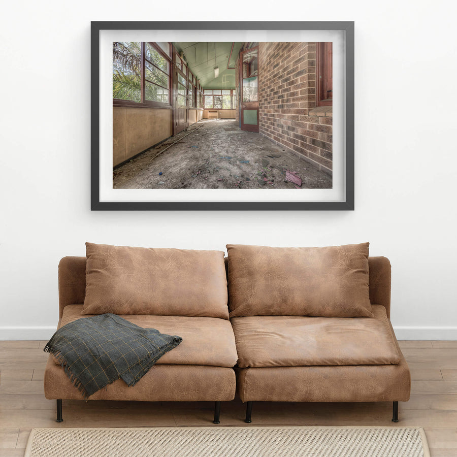Rainforest Escape at Waterfall Sanatorium, a covered verandah runs along the brick facade of a ward building.