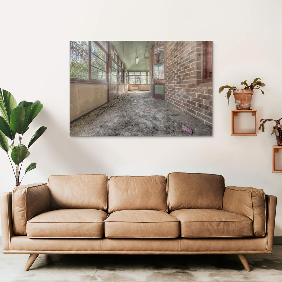 Rainforest Escape at Waterfall Sanatorium, a covered verandah runs along the brick facade of a ward building.