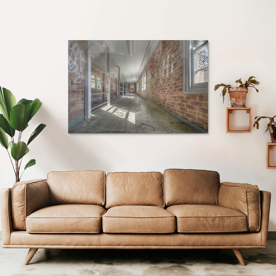 Switchback at Waterfall Sanatorium, a long corridor stretches deep into the building, flanked by brown brick walls thick.