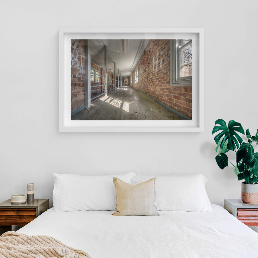 Switchback at Waterfall Sanatorium, a long corridor stretches deep into the building, flanked by brown brick walls thick.