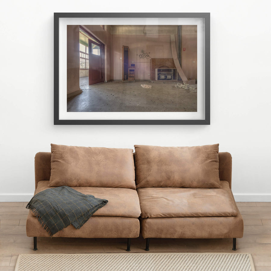 The Fireplace at Waterfall Sanatorium, a brick fireplace sits against the far wall, its arched opening now stuffed.