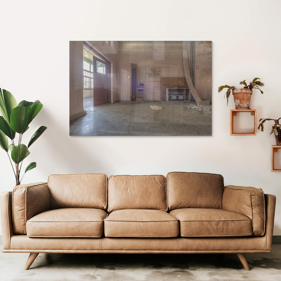 The Fireplace at Waterfall Sanatorium, a brick fireplace sits against the far wall, its arched opening now stuffed.