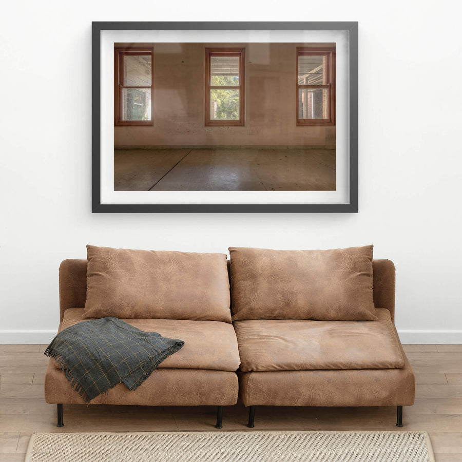 Three Windows at Waterfall Sanatorium, three timber-framed windows sit evenly spaced across a rendered wall.