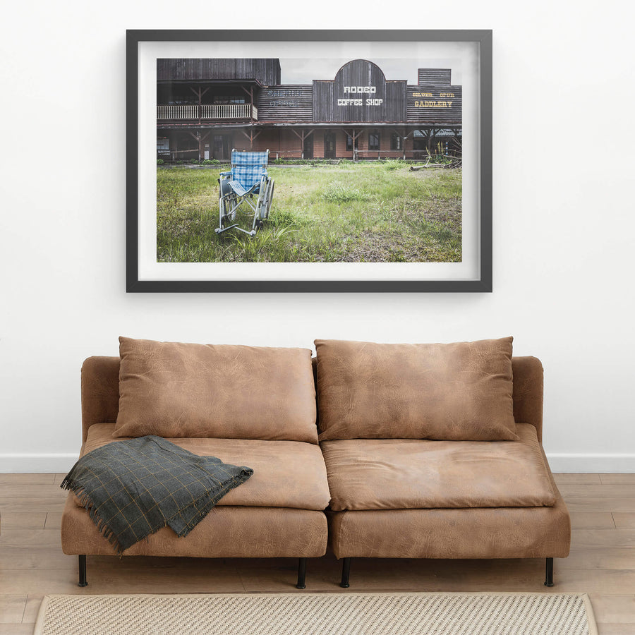 Rodeo Coffee Shop at Western Village, a wheelchair sits on an overgrown lawn in front of the coffee shop.