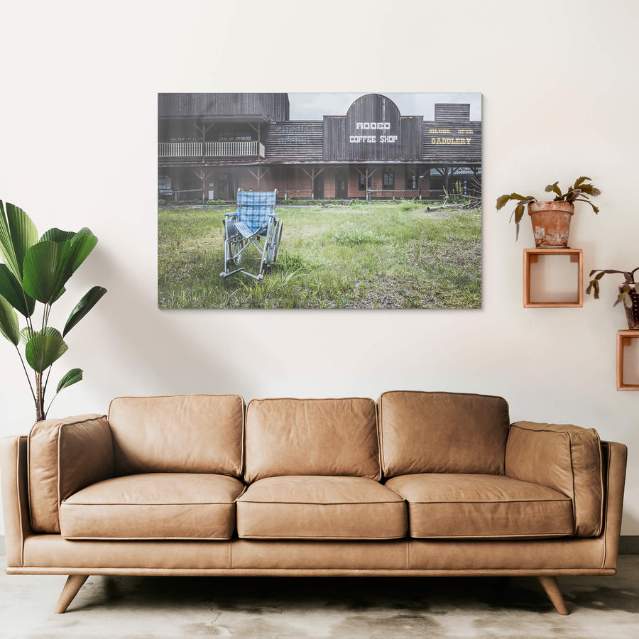 Rodeo Coffee Shop at Western Village, a wheelchair sits on an overgrown lawn in front of the coffee shop.