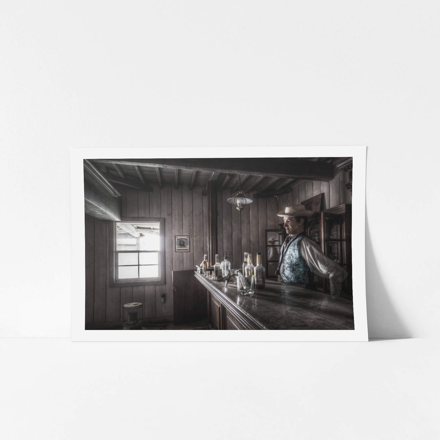 Saloon at Western Village, the bartender of the Western Village saloon stands behind the dimly lit bar.