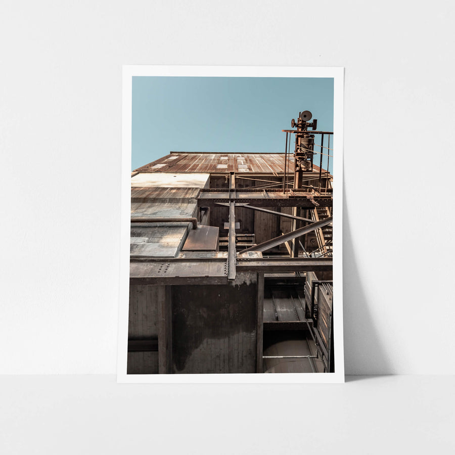Ash Handling Tower Lookup at White Bay Power Station, steel beams and concrete walls stack upward in heavy layers.