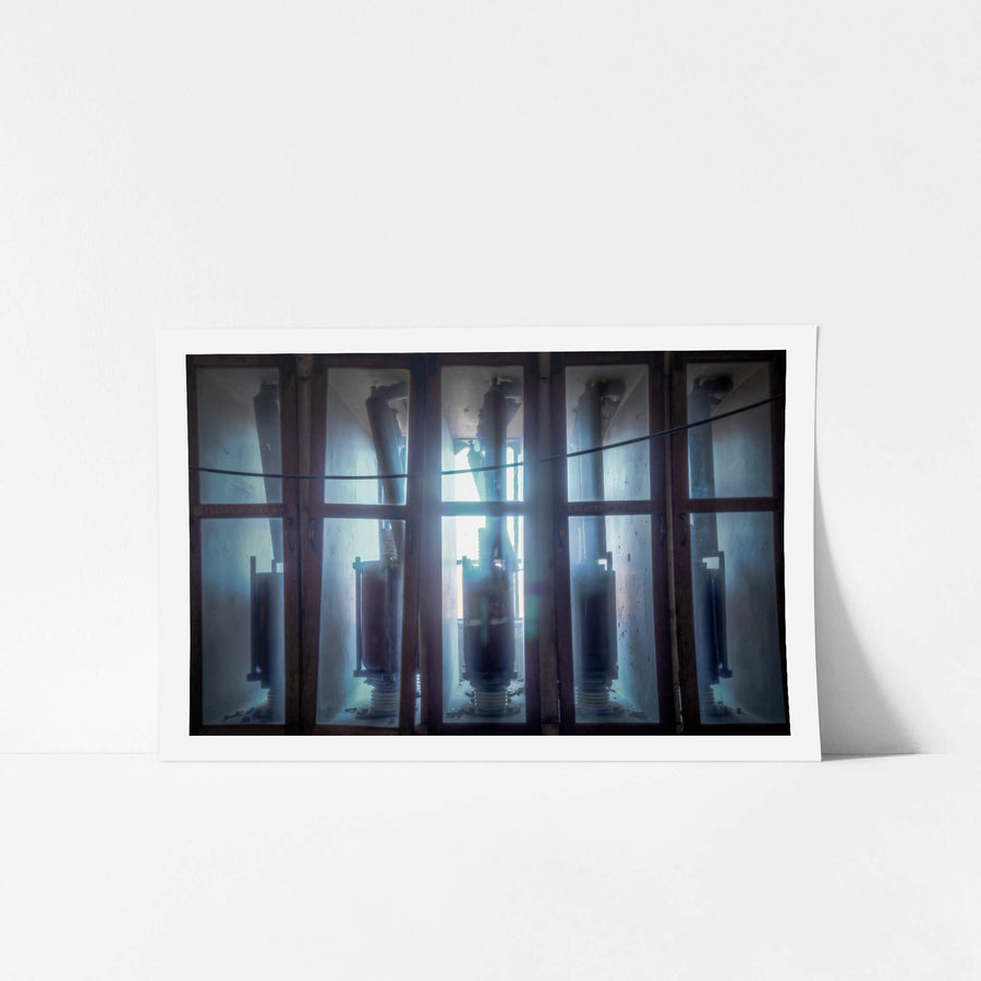 Backlit Reactors at White Bay Power Station, high-voltage reactor switches stand in glass-panelled enclosures, backlit.