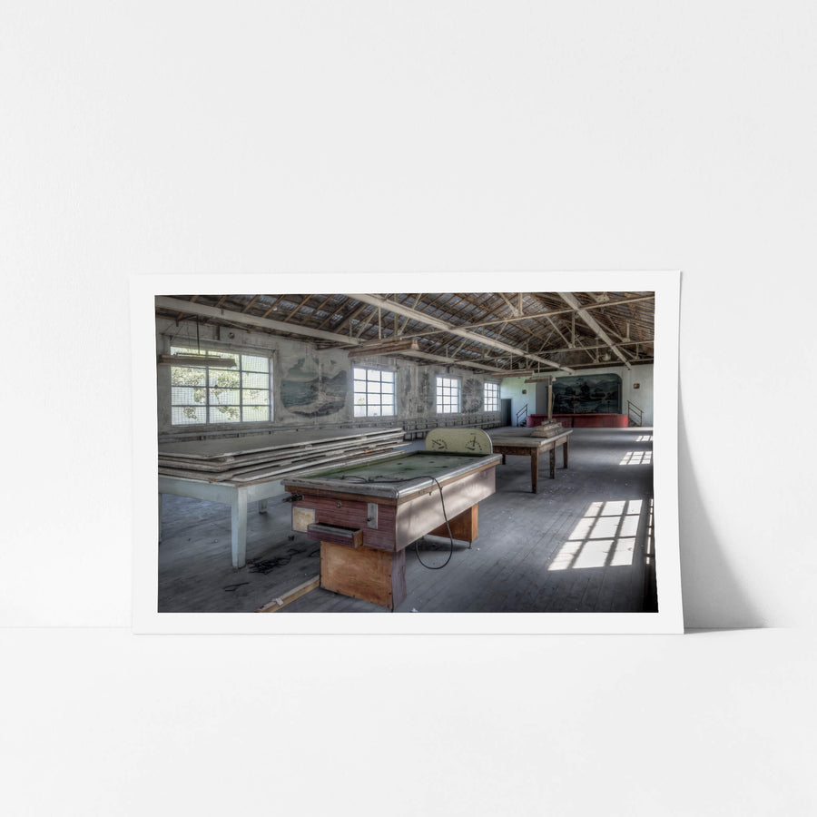 Bar Billiards at White Bay Power Station, a coin-operated bar billiards table sits on worn timber floorboards, its green.