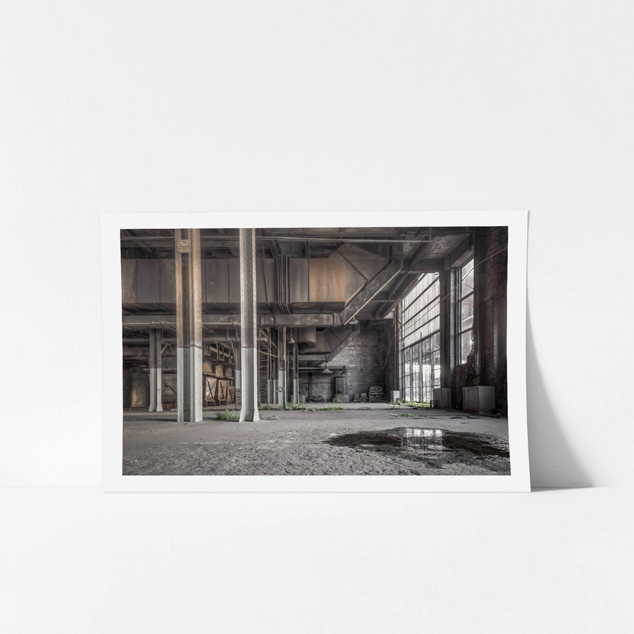 Boiler House Basement at White Bay Power Station, steel columns rise from a concrete floor slick with standing water.