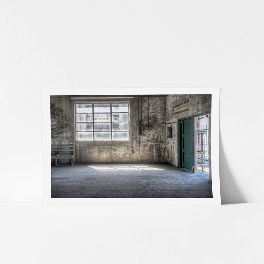 Entertainment Hall Door at White Bay Power Station, light spills through the open doorway, cutting across the worn timber.
