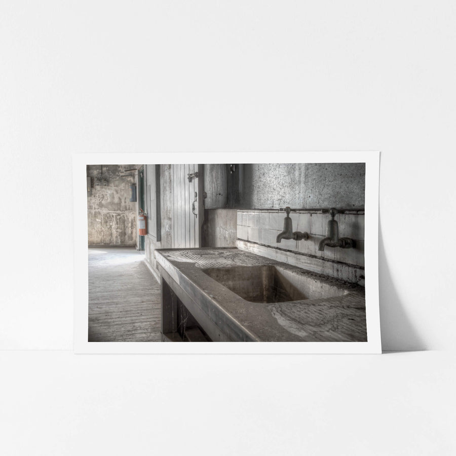 Entertainment Hall Kitchen at White Bay Power Station, the stainless steel sink lies coated in dust, its surface etched.