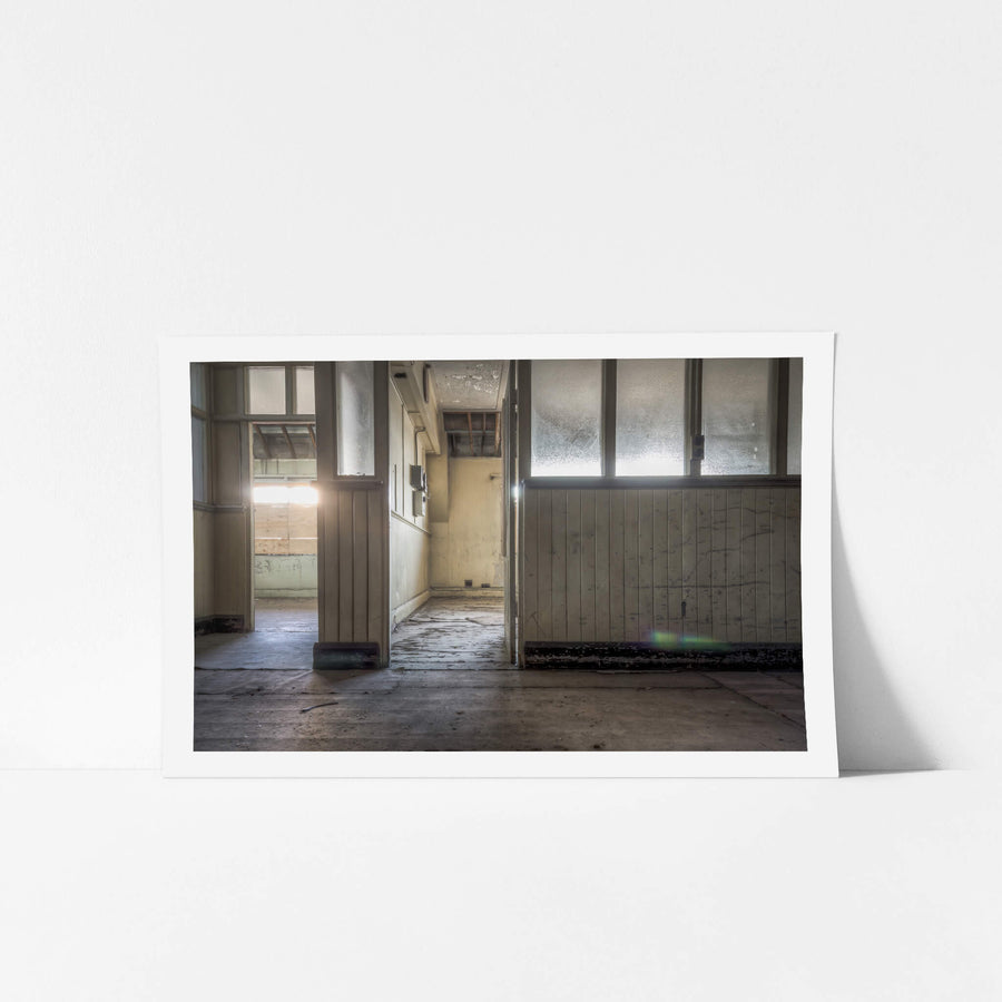 Offices at White Bay Power Station, frosted glass panels line the partition wall, their surface clouded with grime.