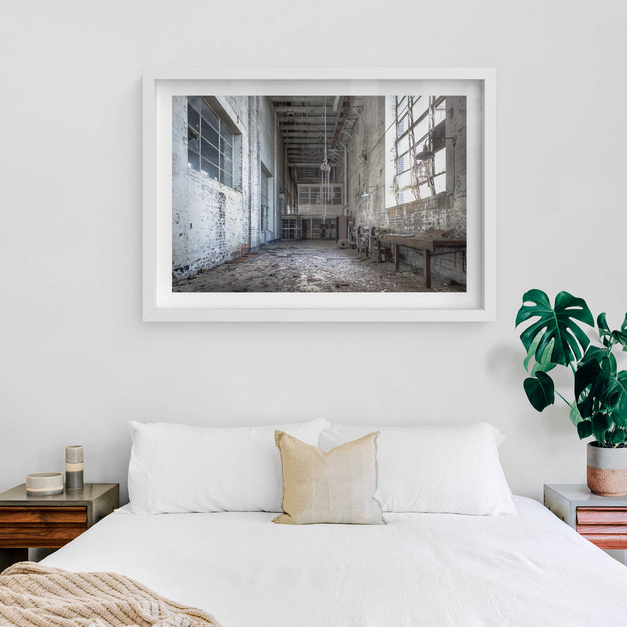Workshop at White Bay Power Station, a chain block hangs from the ceiling on heavy links, motionless above a floor thick.