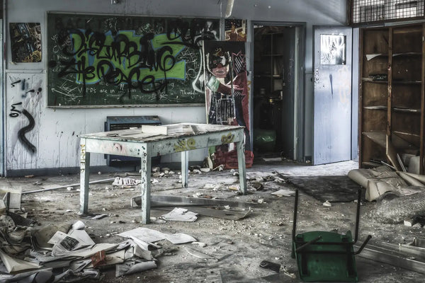 Abandoned classroom at Macquarie Boys Technology High, covered in graffiti and strewn with debris, showcasing the school’s state of decay.