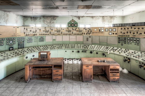 The control room at White Bay Power Station, a sweeping arc of mint green panels covered in dials, gauges, and switches, with two wooden control desks at the centre.