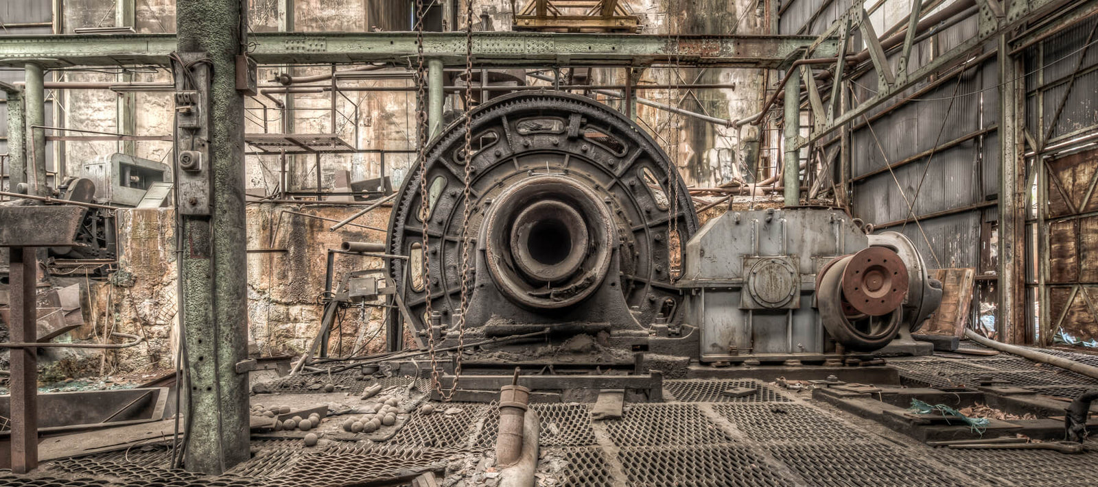 A historic ball mill inside the Tsūdō Ore Dressing Plant Ruins, part of the Ashio Copper Mine in Tochigi Prefecture, Japan. The weathered industrial machinery is set in a deteriorated building, capturing the site’s history and legacy.