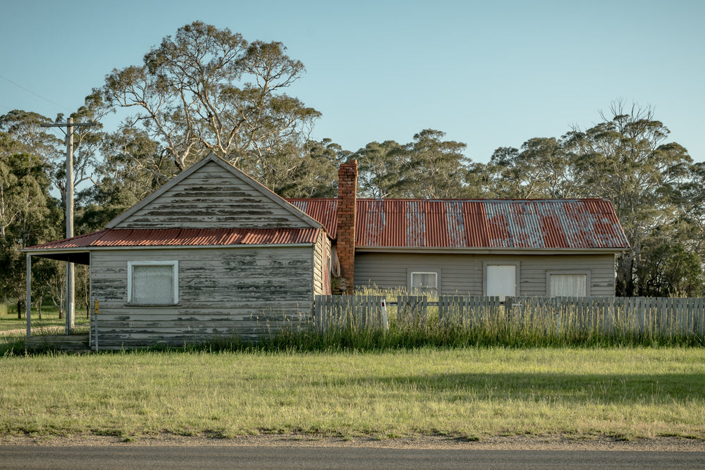 Cathcart Corner at A Place to Call Home, an old, red-roofed timber weatherboard house on the corner of a Cathcart Street.
