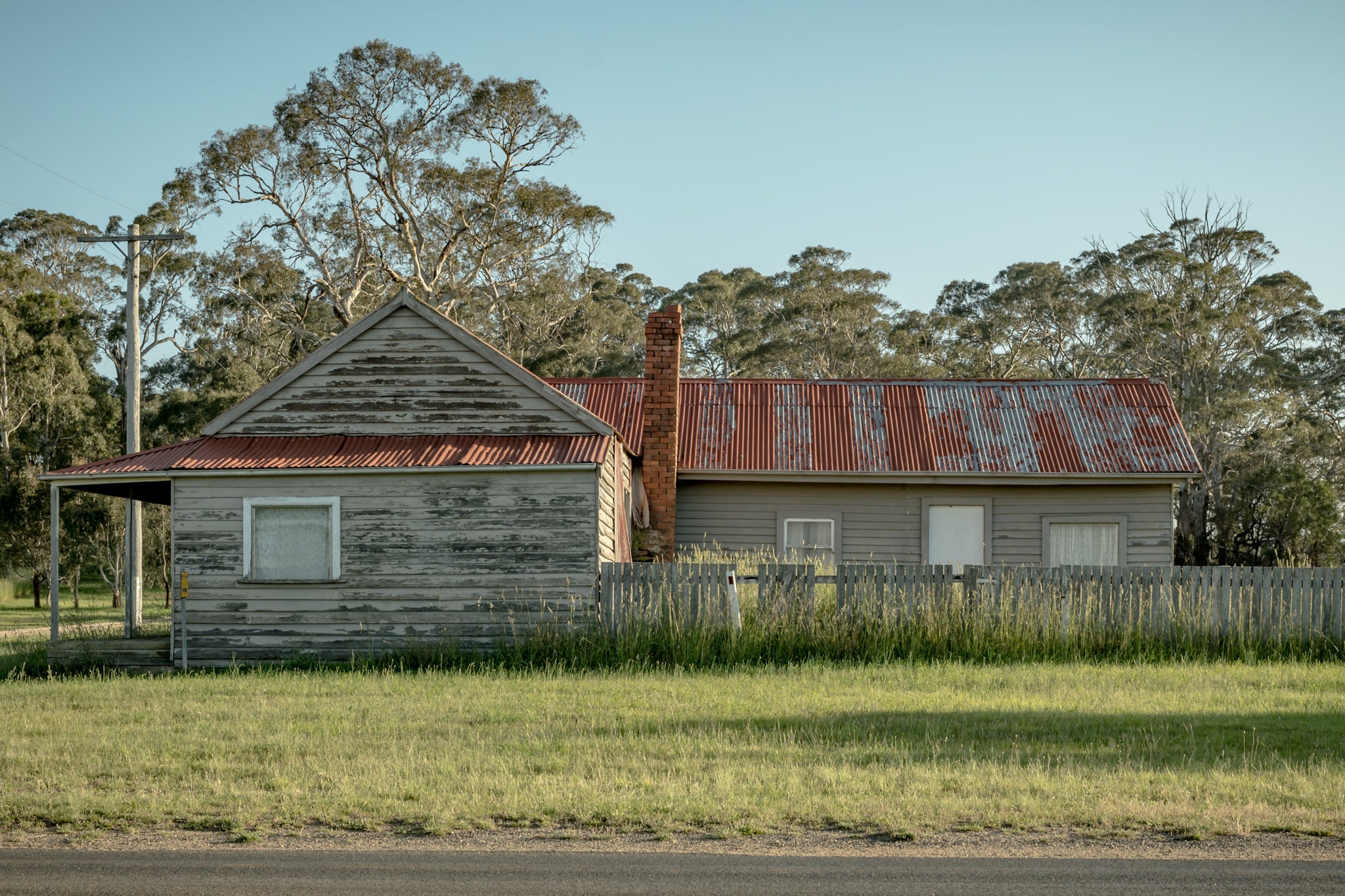 Cathcart Corner at A Place to Call Home, an old, red-roofed timber weatherboard house on the corner of a Cathcart Street.