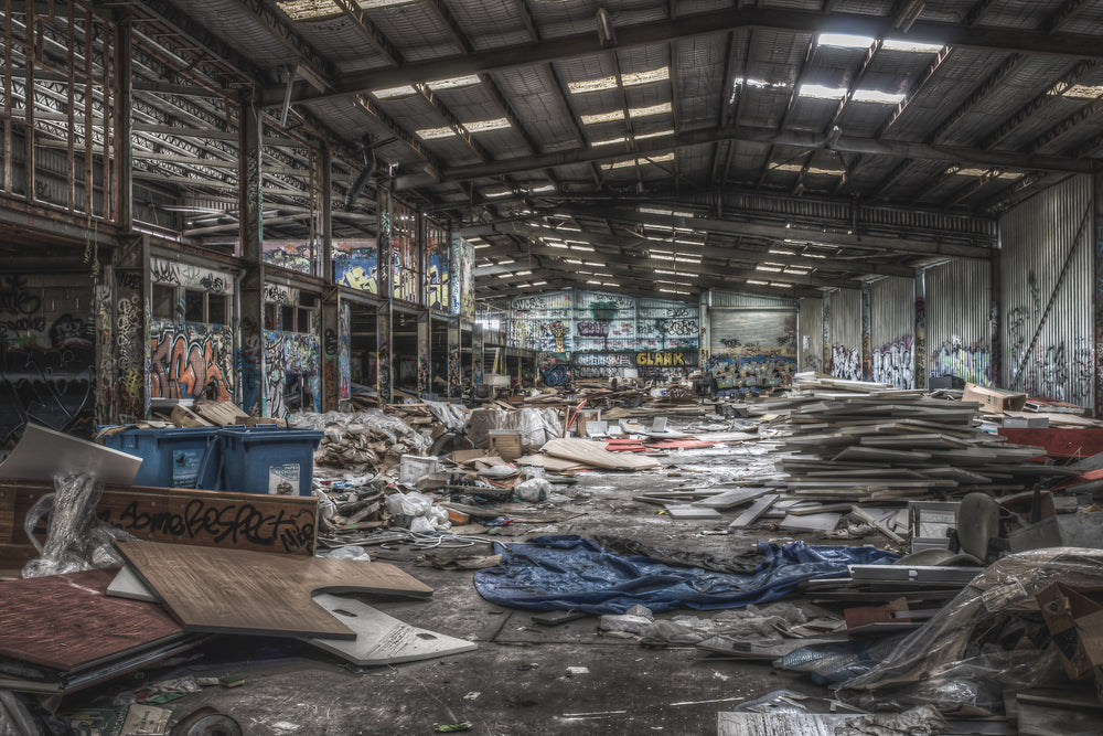 Main Floor West at Abandoned Bakery, steel portal frames span the full width of the warehouse floor.