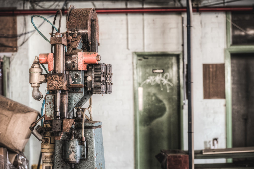 Clicker Press at Abandoned Shoe Factory, a machine used to insert eyelet rivets into lace up shoes.